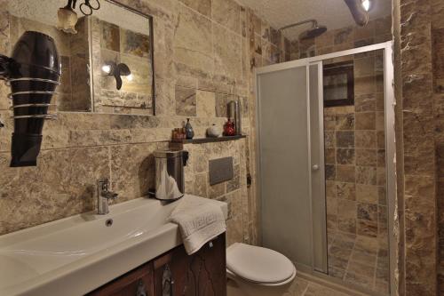 a bathroom with a sink and a toilet and a shower at Old Town Stone House in Goreme