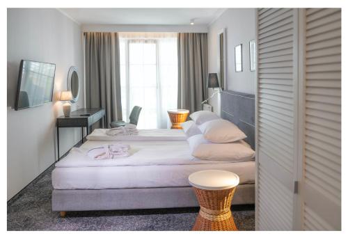 Postel nebo postele na pokoji v ubytování Neptuno Resort & Spa