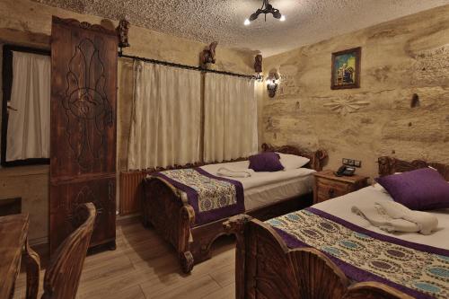 a bedroom with two beds in a room at Old Town Stone House in Goreme