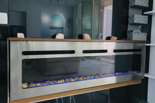a kitchen with an oven with rocks on it at Green Coast Resort V94 in Palasë