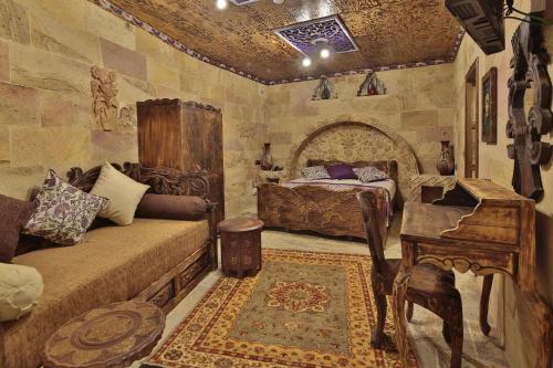 a bedroom with two beds and a table and a piano at Old Town Stone House in Goreme