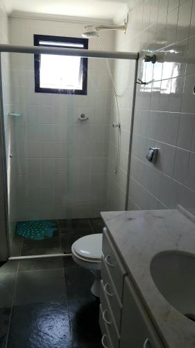 a bathroom with a toilet and a sink at SAN REMO in Guarujá