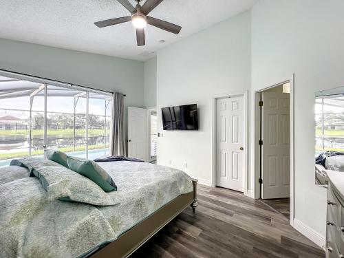 a bedroom with a bed and a ceiling fan at Glenbrook Pool Lake Home in Orlando