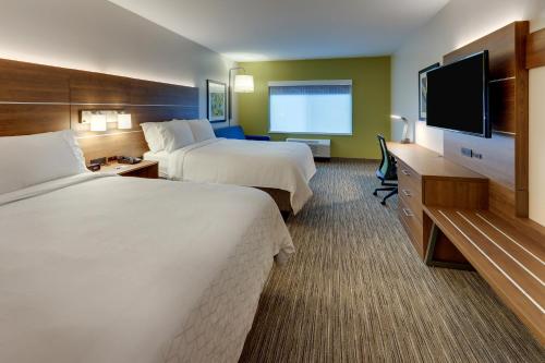 a hotel room with two beds and a flat screen tv at Holiday Inn Express & Suites - Saugerties - Hudson Valley by IHG in Saugerties