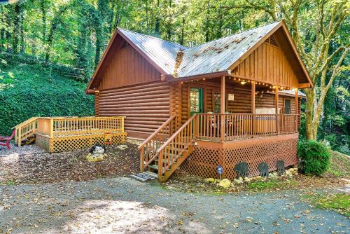 a cabin in the woods with a large deck at Bear Nakid in Pigeon Forge