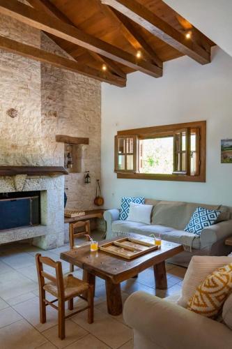 a living room with a couch and a table at Platanos in Vasiliki