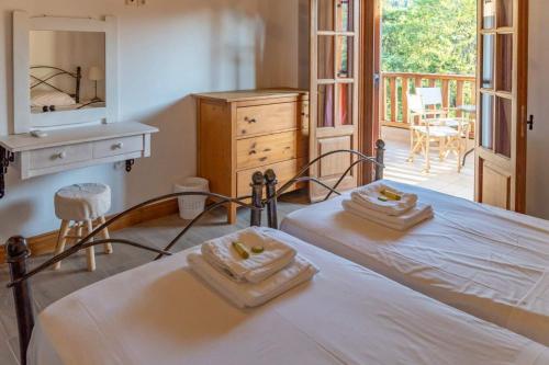 a bedroom with a bed with two towels on it at Platanos in Vasiliki