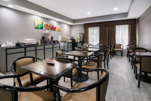 a restaurant with tables and chairs and a counter at Quality Inn & Suites - Granbury in Granbury