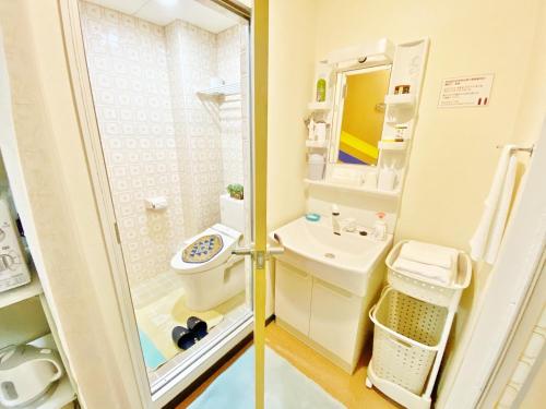 a small bathroom with a toilet and a sink at Petit Hotel 017 - Vacation STAY 36979v in Tokushima