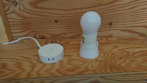 a wii remote and a charger on a wooden floor at Sarabetsu-mura chiiki Kouryu Center - Vacation STAY 31370v in Naka-satsunai