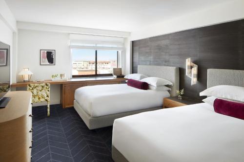 a hotel room with two beds and a desk at Kimpton Alton Fisherman's Wharf by IHG in San Francisco