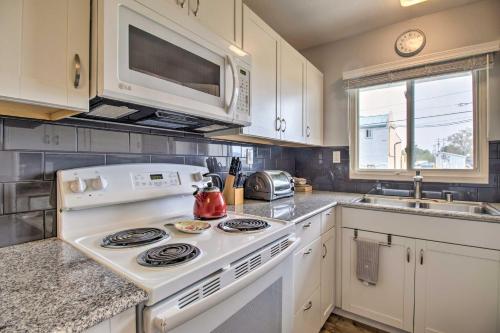 a kitchen with a white stove and a microwave at BBQ Ready with Patio Walkable Carson City Duplex in Carson City