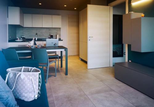 a kitchen and dining room with a table and chairs at Bellavista in San Lorenzo al Mare