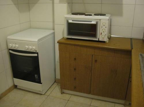 eine Küche mit einer Mikrowelle und einem Herd in der Unterkunft Aegean Hotel in Agía Triás
