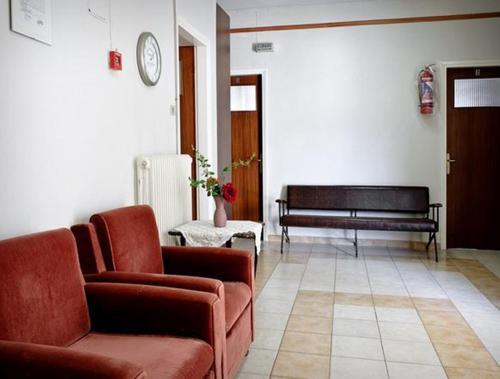 a living room with a couch and a bench at Aegean Hotel in Agia Triada