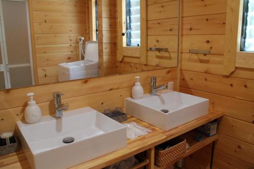 a bathroom with two sinks and a mirror at NEXX IKI - Vacation STAY 16966v in Iki
