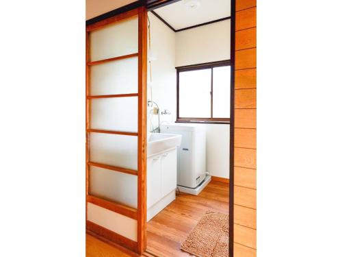 a bathroom with a tub and a sink and a window at Second House Nikko - Vacation STAY 13408 in Nikko