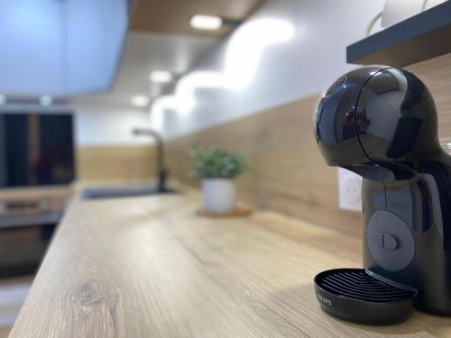 a hair dryer sitting on top of a table at AppartChic - appartement standing - plein Centre & Parking privé in Créon