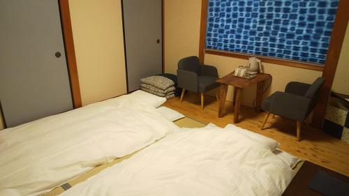a hospital room with a bed and two chairs and a window at Guest House Nishimura - Vacation STAY 13438 in Kyoto