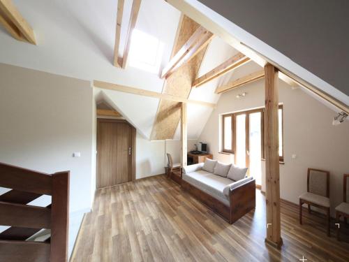 a living room with a couch and wooden floors at Willa Alicja in Ustroń