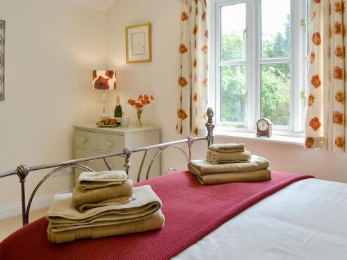 a bedroom with a bed with towels on it at Bondgate in Helmsley