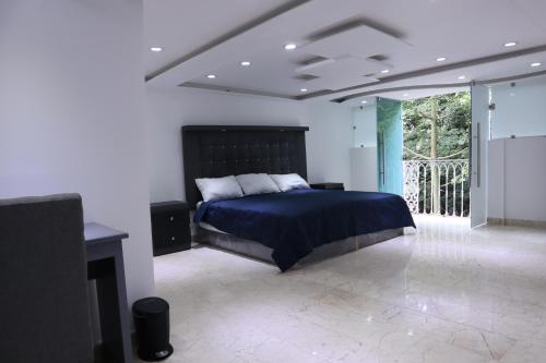 a bedroom with a bed and a tv in it at London 248 in Mexico City
