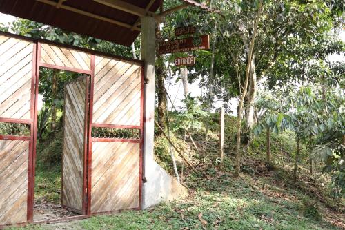 an open door of a building with a street sign at Candurumy Lodge in Tena