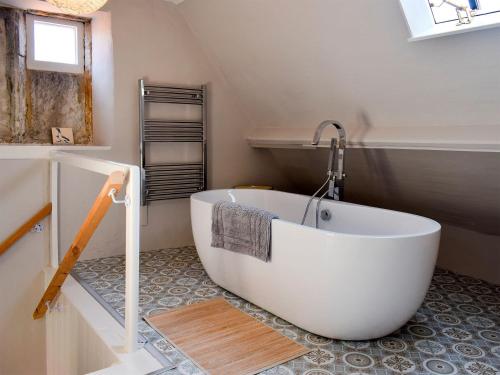 a bathroom with a large white tub in a room at Rosslyn House in Robin Hood's Bay