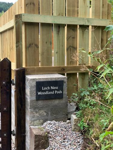 a wooden fence with a sign that readsouth nest woodland rock at Loch Ness Woodland Pods in Drumnadrochit