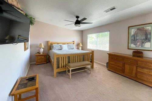 a bedroom with a bed and a ceiling fan at Condo with Resort Amenities, by Downtown St George! in St. George