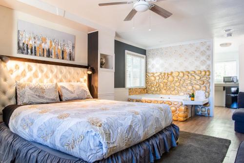 a bedroom with a large bed and a ceiling fan at Big Bear Spa Suites in Big Bear Lake