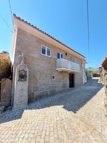 a building with a cross on the side of it at Casa do Sobrado Arouca in Arouca