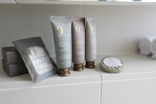 a shelf with three products on top of a counter at Realm Apartments by CLLIX in Adelaide