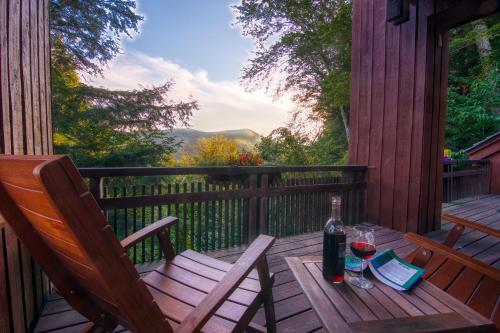 una mesa de madera con 2 copas de vino en una terraza en Gnome Home Mountain Ski Chalet w/Sauna Killington, en Stockbridge