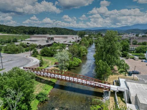 a bridge over a river in a town at Holiday Inn & Suites Pigeon Forge Convention Center by IHG in Pigeon Forge