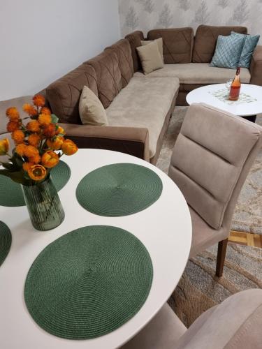 a living room with two tables and a couch at AS Delux Apartmani in Soko Banja