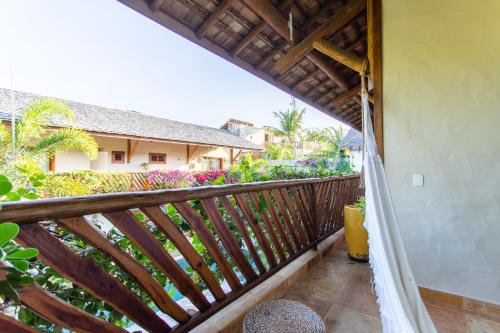 a balcony with a view of a house at VillaMag in Jericoacoara
