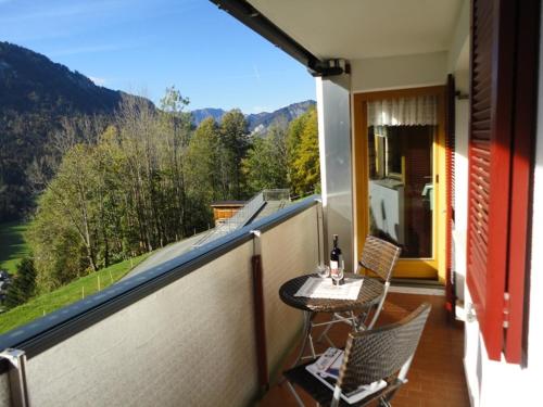 a balcony with two chairs and a table with a view at Haus Sonnberg in Mellau