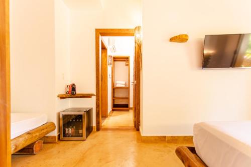 a room with a fireplace and a room with a bed at VillaMag in Jericoacoara