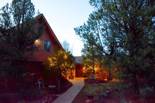a house with a pathway leading to a yard with trees at The Roost Apartment SEDONA'S MOST LOVED in Sedona