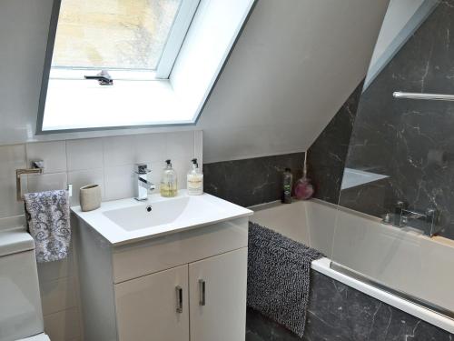 a bathroom with a sink and a skylight at The Old Forge in Alnwick