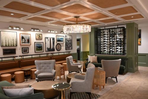 a restaurant with chairs and tables and a chandelier at Six South St. Hotel in Hanover