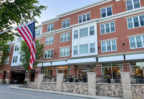 an american flag flying in front of a building at Six South St. Hotel in Hanover
