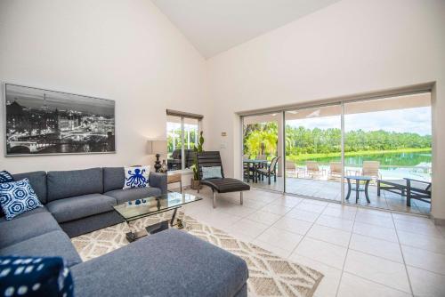 a living room with a couch and a table at SWISS 66 - Lake Denise in Clermont
