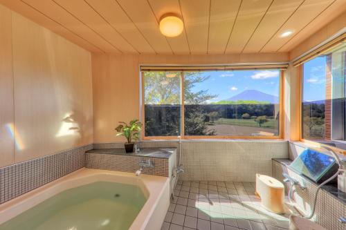 a bathroom with a tub and a window at SILVER SPRAY MtFuji view Yamanakako in Yamanakako