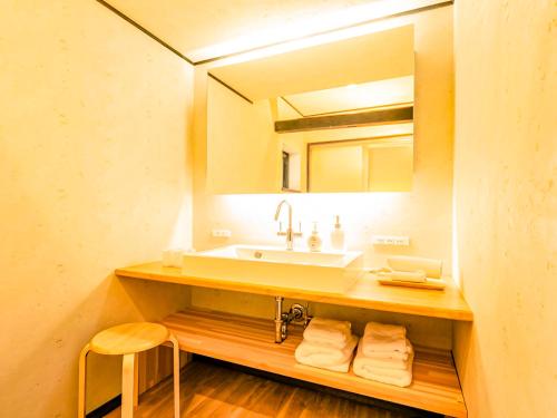a bathroom with a sink and a mirror at 古民家　宿　そよも in Nagahama