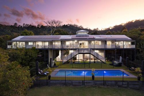 a large house with a pool in front of it at The Country House at Hunchy Montville in Montville