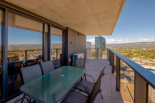 a balcony with a table and chairs and a view at Realm Apartments by CLLIX in Adelaide