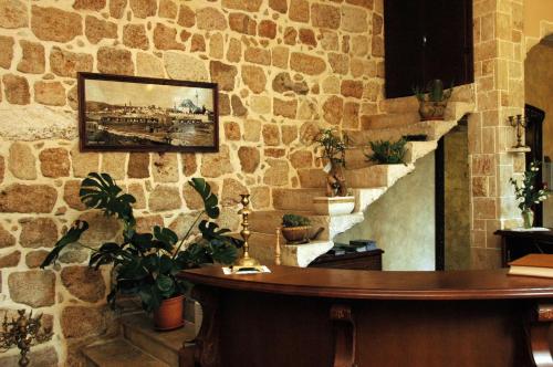 
a large stone wall with a clock on top of it at Akkotel-Boutique hotel in Acre
