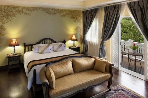 a bedroom with a large bed and a large window at Ping Nakara Boutique Hotel And Spa in Chiang Mai